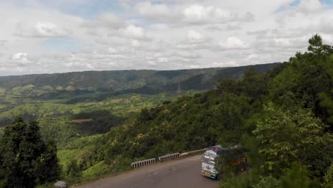 Car-passing-by-curvy-mountain-roads-of-Meghalaya,-India
