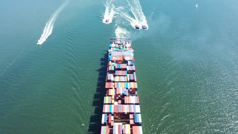 An-aerial-shot-of-a-cargo-ship-with-colorful-containers-on-board