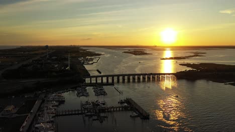 An-aerial-shot-over-a-quiet-marshland-with-a-bridge