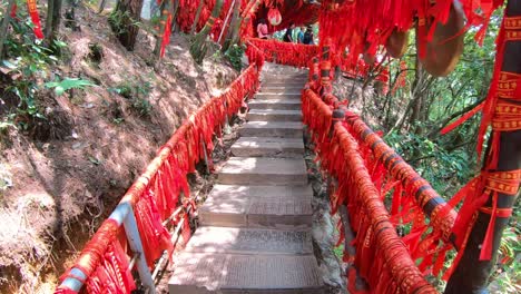 Red-ribbons-tied-to-the-barriers-along-the-walking-path-in-Tianzi-mountains-in-Zhangjiajie-National-park-which-is-a-famous-tourist-attraction,-Wulingyuan,-Hunan-Province