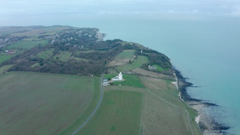 Descending-drone-shot-of-south-foreland-lighthouse-white-cliffs-of-Dover