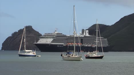 Holland-America-Line-Cruise-ship-in-Taiohae-bay,-Nuku-Hiva,-Marquesas-Islands,-French-Polynesia,-small-sailboats-around