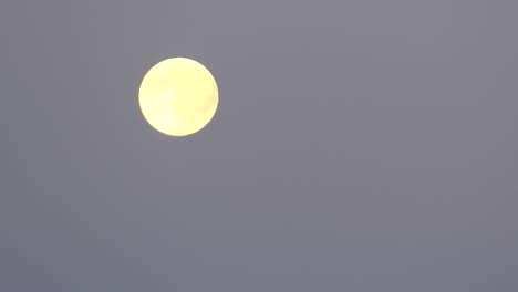 Yellow-moon-moving-across-sky.-Time-lapse