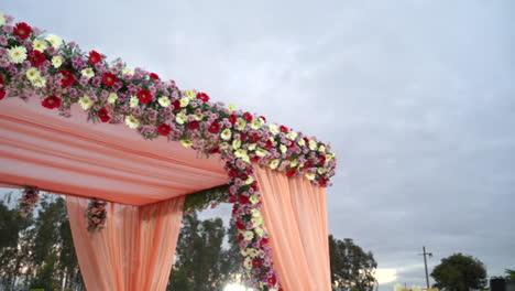 Beautifully-decorated-outdoor-wedding-arch-with-variety-of-colourful-flowers