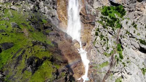 Slow-drone-flight-near-a-waterfall-with-a-light-rainbow---Ordesa-fall-River-Cinca-in-Pineta