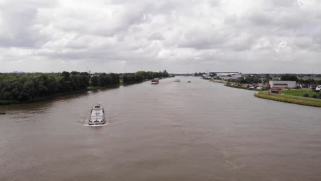 Aerial-View-Of-Inland-Freighter-Turning-On-River-Noord-At-Ridderker