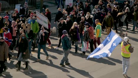 Large-Quebec-flag-leading-a-marching-protest-in-Montreal