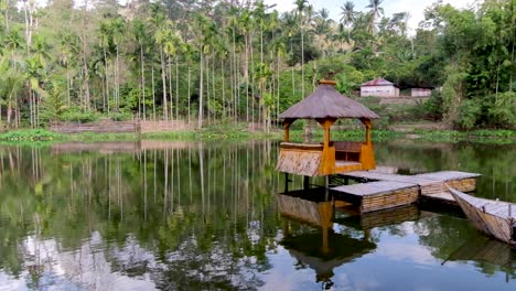 Idyllic-bamboo-hut-pontoon-with-traditional-thatched-roof-on-the-water-surrounded-by-trees-in-Timor-Leste,-Southeast-Asia