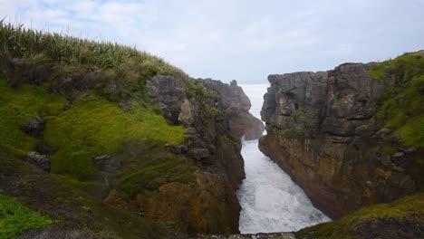 Wild-waves-hitting-into-cliffs-creating-a-blowhole