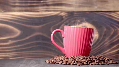 4k-hand-puts-a-mug-into-coffee-beans-with-wooden-backdrop---studio-shot