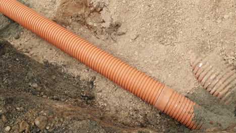Orange-Pvc-Pipes-During-Installing-Sewage-Line-In-A-Village-At-Leiria,-Portugal
