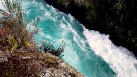 Whitewater-rapids-rushes-through-a-narrow-passage-on-Waikato-River-at-Huka-Falls-in-Taupo,-New-Zealand-Aotearoa