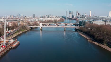 Descending-drone-shot-over-London-river-thames-at-battersea-power-station-Chelsea-Bridge