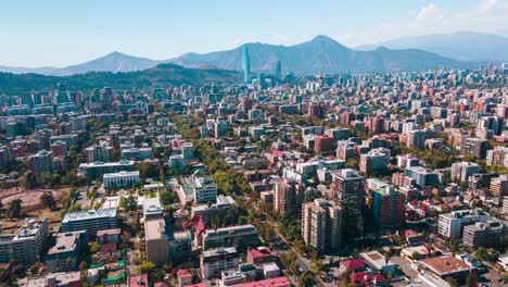 Aerial-hyperlapse-over-Ñuñoa-at-Santiago-de-Chile-on-a-sunny-day-with-mountains-and-buildings-in-the-background