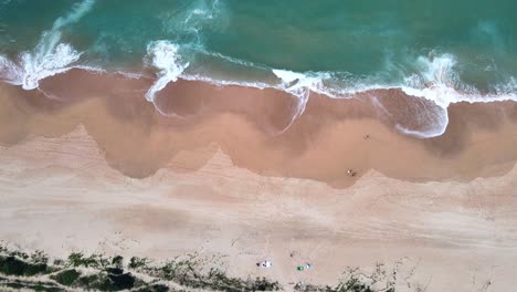 Aerial-Top-View-of-a-few-people-enjoying-beach-time-in-the-south-of-Brazil