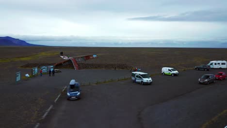 Tourists-Exploring-Historical-Landmarks-In-Iceland---aerial-shot