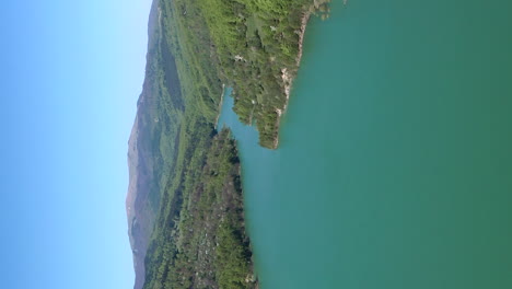 Aerial-parallax-above-lake-formed-by-Maneciu-Dam,-Romania