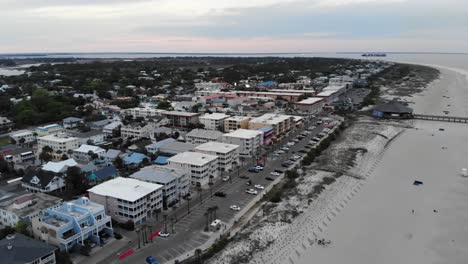 tybee-island-south-end-pier-shops-restaurants-lodging-vacation-beach-sunset-aerial-drone-rotate