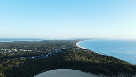 Hohe-Drohnenansicht-Mit-Blick-Auf-Den-Carlo-Sand,-Der-In-Richtung-Fraser-Island,-Queensland,-Australien,-Ausgeblasen-Wird
