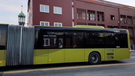 Green-EV-electric-bus-driving-over-a-canal-bridge-in-Trondheim
