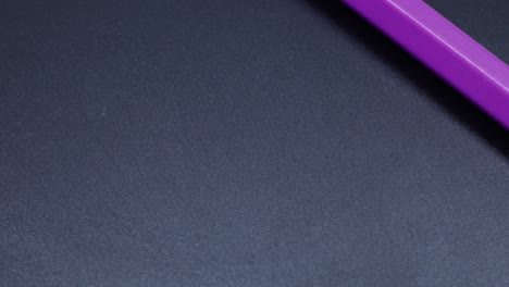 Purple-colored-pencil-crayon-rotating-macro-shot,-zoom-close-up-video
