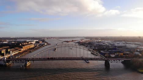 Aerial-Drone-View-Of-Brug-Over-De-Noord-With-Traffic-And-Barges-Approaching-On-Sunny-Afternoon