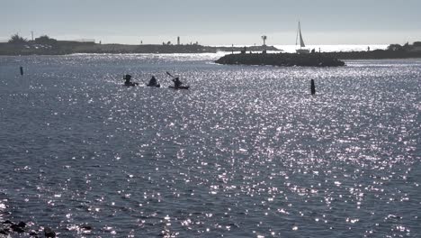 People-kayaking-and-fishing-at-Moss-Landing-Harbor-in-Monterey-County,-California