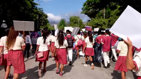Students-in-school-uniforms-marching-down-the-streets-with-climate-change-signs-during-the-global-climate-strike-protest-in-capital-Dili,-Timor-Leste