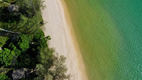 Top-down-aerial-drone-view-of-Koh-Rong-island-in-Cambodia,-beach-and-coast,-sunny-day