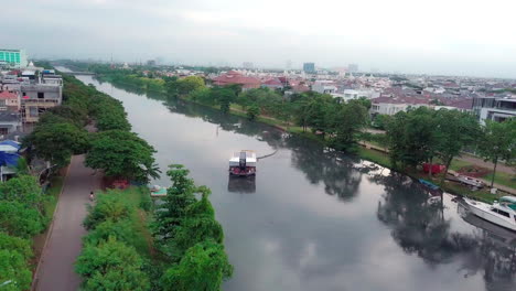 Dynamic-Aerial-Wide-Parallax-Shot-of-Interceptor-River-Cleanup-Machine-in-Indonesia