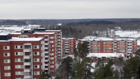Stockholm-Apartment-Buildings-With-Winter-Snow-Cover---Aerial-Flyover