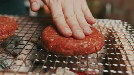 Close-up-on-ground-meat-beef-patties,-grilled-on-hot-charcoal-outdoor-grill