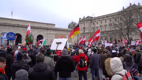 Many-national-flag-being-waved-at-anti-corona-protests-against-government-in-Vienna,-Austria