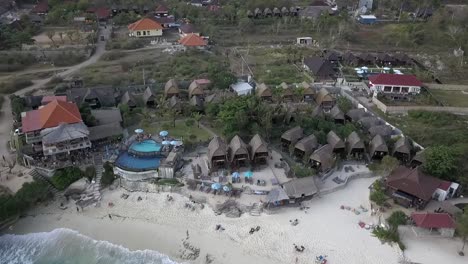 Spectacular-high-aerial-view-flight-top-down-drone-footage-ot-idyllic-dream-beach-with-beachfront-resort-in-Nusa-Lembongan-at-midday-noon-time-in-bali-2017