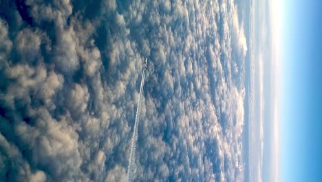 Unique-video-of-flying-airplane-over-clouds,-high-angle-aerial-view