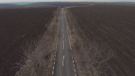 Drone-Ascends-Over-Empty-Asphalt-Road-In-The-Middle-Of-Nowhere