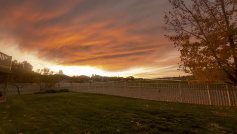 Backyard-sunrise-is-colorful-as-dawn-breaks-in-a-suburban-neighborhood---time-lapse