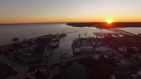 Aerial-Drone-Flyover-of-Oriental-NC-Harbor-and-town-docks-at-sunset-forward-flight-with-Diesel-Spill-facing-south
