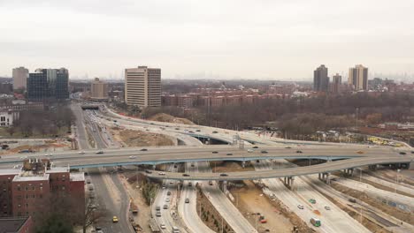 An-aerial-view-of-a-highway-intersection-with-flowing-urban-traffic-on-a-cloudy-Sunday-afternoon-in-winter