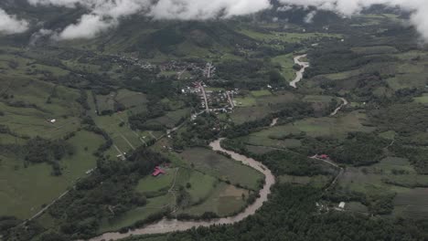 High-aerial-tilt-follows-Huancabamba-River-flowing-in-rich-Peru-valley