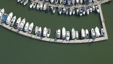 Top-down-aerial-view-of-boats-parking-on-the-boathouse