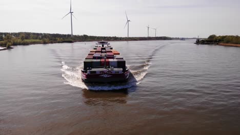Aerial-View-From-Forward-Bow-Of-Petran-Cargo-Ship-Along-Oude-Maas-With-Windmills-Seen-In-Background