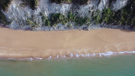 Great-aerial-view-flight-slider-fly-sideways-from-right-to-left-drone-footage-of-the-coastline-and-waves-at-paradise-nature-canyon-dream-Beach-Corfu-Greece