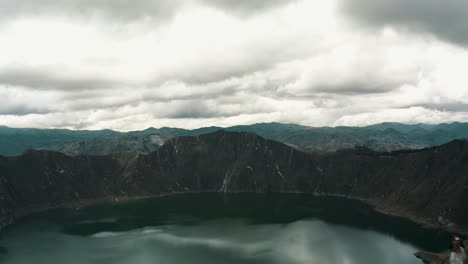 Drone-Fly-Over-Quilotoa-Lake-With-People-On-The-Hilltop-In-Ecuador