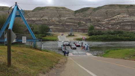 One-of-the-few-Ferries-still-in-operation-today,-the-Bleriot-Ferry-offloads-vehicles-after-crossing-the-Red-Deer-River
