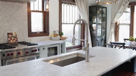 real-estate-shot-of-a-modern-sink-and-faucet-in-a-large-luxury-kitchen
