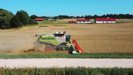 Penkule-village,-Latvia---September-2,-2022:-Aerial-View-of-Harvester-Machines-Working-in-Wheat-Field