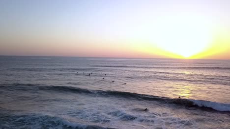 Slow-motion-of-friends-meeting-for-surfing-at-sunset-on-weekend