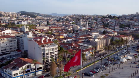 Aerial-View-Of-Ataturk-Boulevard-In-Kusadasi,-Turkey-With-Landmarks,-Built-Structures,-And-Turkish-Flag-At-Daytime