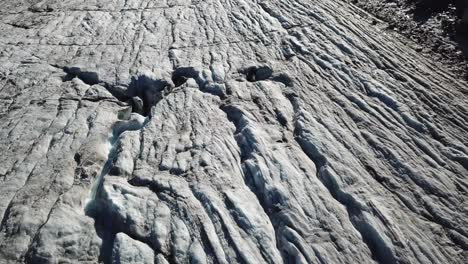 Top-view-of-a-glacier-with-ridges,-crevasses